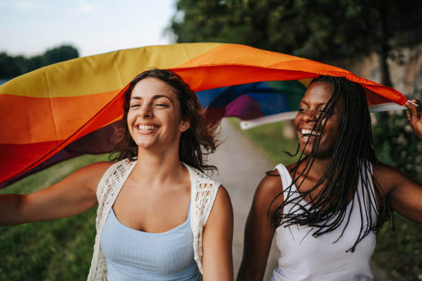 Lesbian Couple with Pride Flag LGBTQ family rights signified by couple with pride flag. 